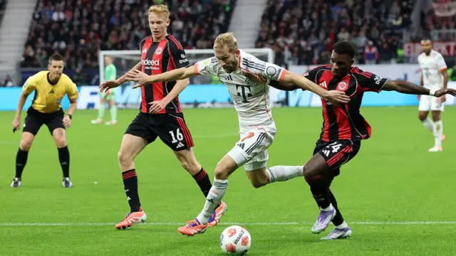 Konrad Laimer of Bayern Munich is is challenged by Buta of Eintracht Frankfurt