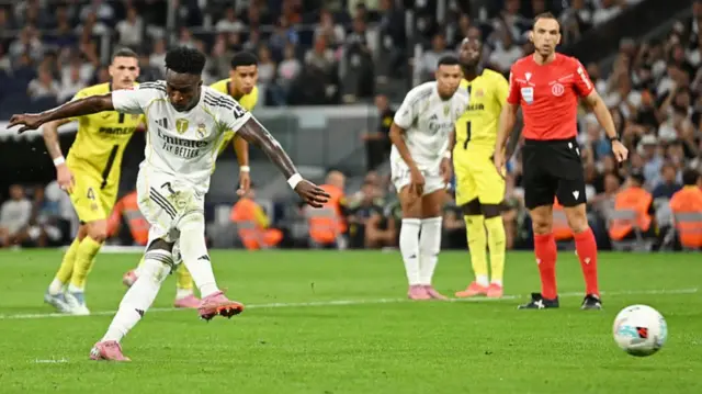 Vinicius Junior of Real Madrid scores his team's second goal from the penalty spot