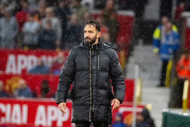 Amorim stands soaked wet through on the touchline