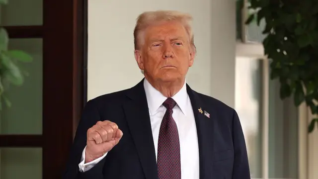U.S. President Donald Trump pumps his first as he waits to welcome Israeli Prime Minister Benjamin Netanyahu at the White House on September 29, 2025 in Washington, DC. I