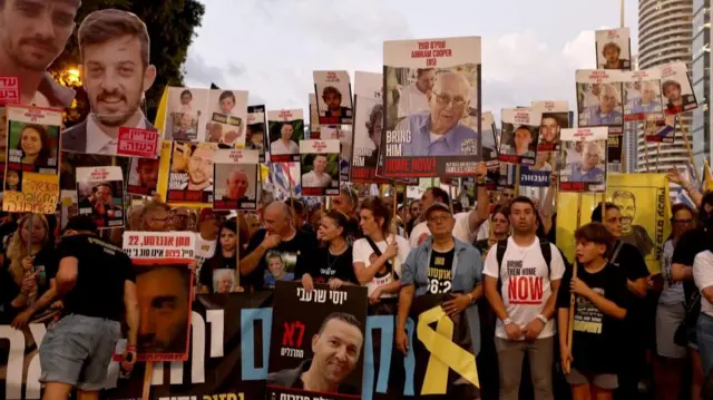 Protesters holding signs of hostages photos in Tel Aviv - 26 Aug 2025