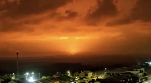 Orange explosion seen on Gaza skyline