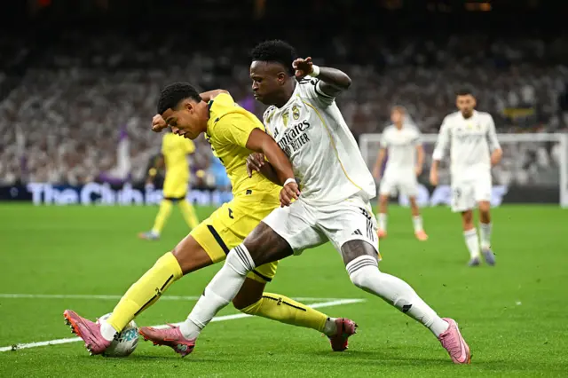 Santiago Mourino of Villarreal CF is put under pressure by Vinicius Junior of Real Madrid