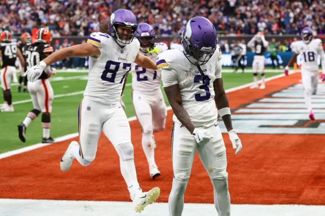 TJ Hockensen runs to celebrate with Jordan Addison after Addison scores the match-winning touchdown for Minnesota Vikings against Cleveland Browns