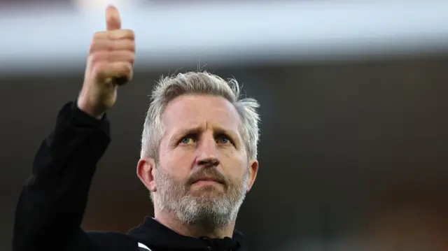 Dennis Betts putting his thumb up to the crowd after a match.