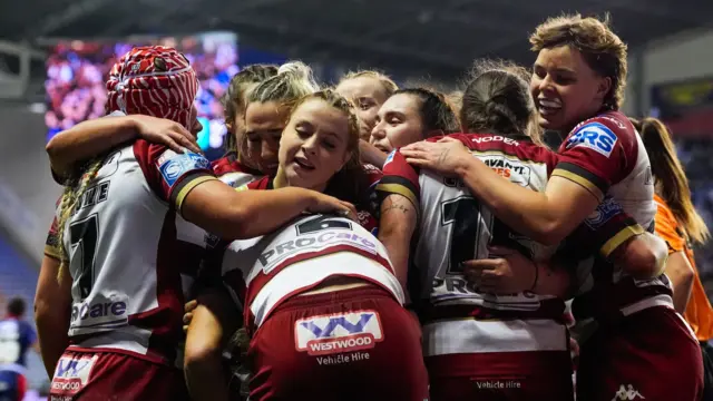 Anna Davies of Wigan celebrating her try with Grace Banks of Wigan