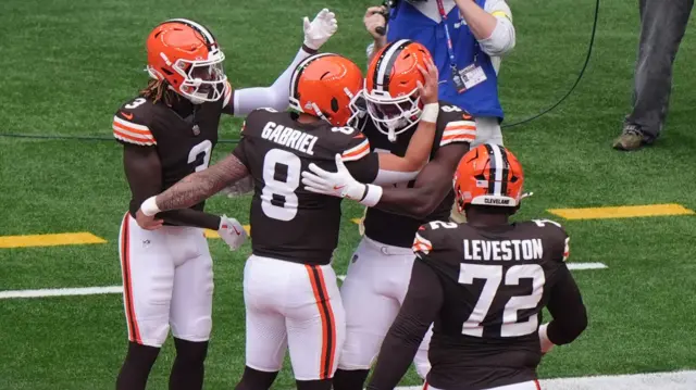 Dillon Gabriel congratulates Harold Fannin after he scores a touchdown for the Minnesota Vikings against the Cleveland Browns
