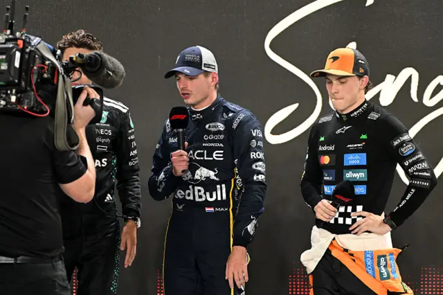 Max Verstappen holds the microphone during the post-qualifying interviews
