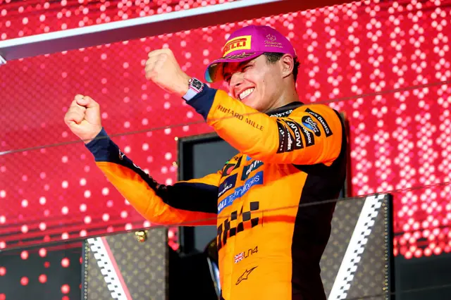 Lando Norris celebrating on the podium in Singapore