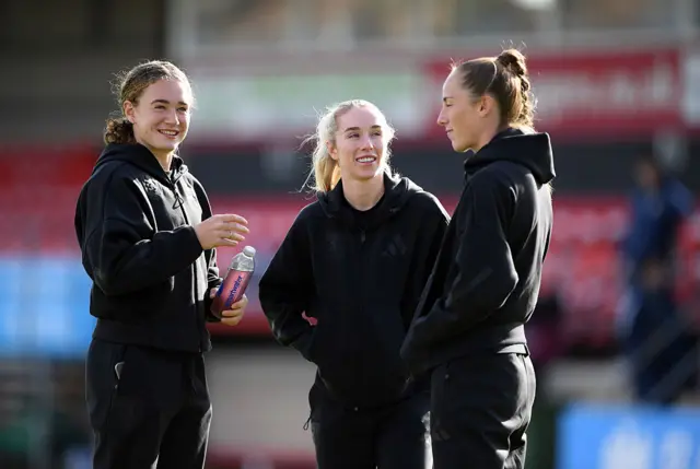 Villa players chat on the pitch pre-match