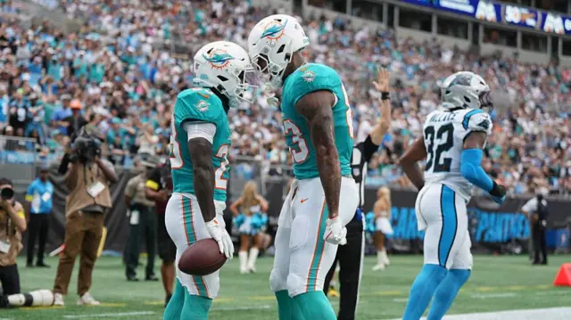 The Miami Dolphins celebrate in the NFL