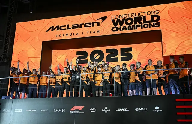 McLaren celebrate on the podium after winning the constructors' championship
