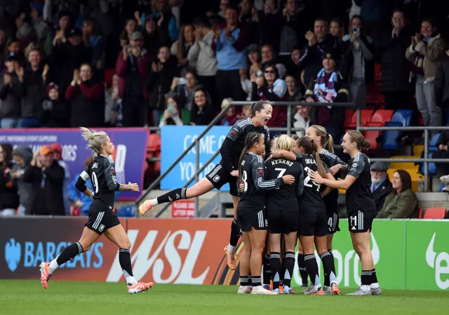 Kirsty Hanson of Aston Villa (obscured) celebrates scoring her team's first goal with teammates during the Barclays Women's Super League match between West Ham United and Aston Villa at Chigwell Construction Stadium on October 05, 2025 in Dagenham, England.