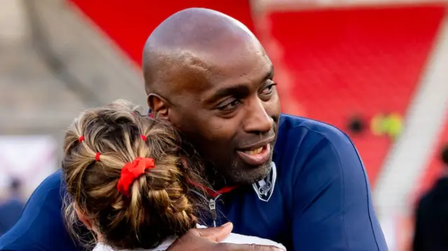 St Helens coach Craig Richards hugs his players after their victory over York.