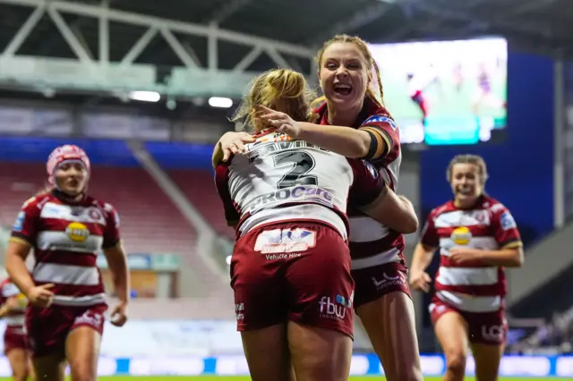 Anna Davies of Wigan celebrating her try with Grace Banks of Wigan