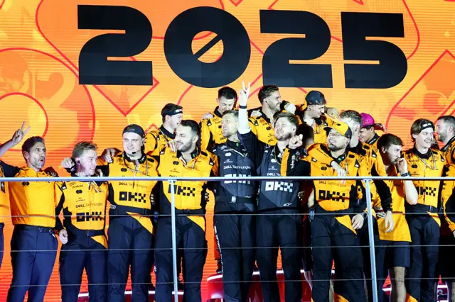 McLaren celebrate on the podium after winning the teams' championship