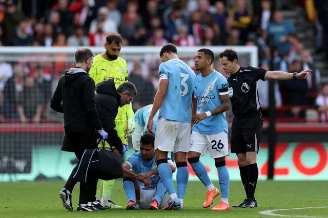 surrounded by players and medics