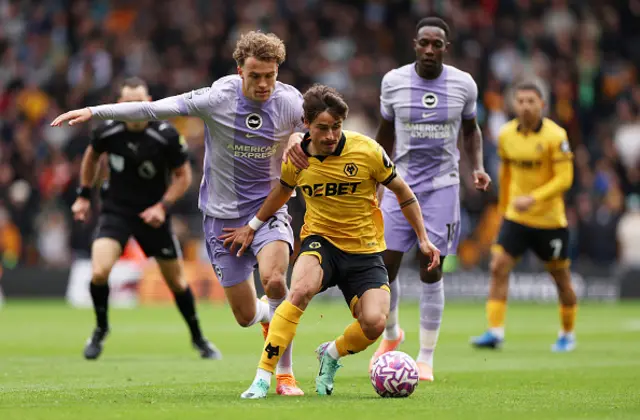 Hugo Bueno of Wolverhampton Wanderers runs with the ball whilst under pressure from Mats Wieffer
