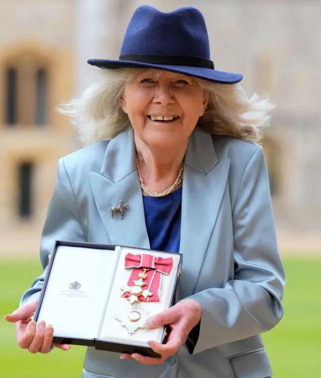 Dame Jilly Cooper after being made a Dame Commander of the British Empire by King Charles III at Windsor Castle, Berkshire.