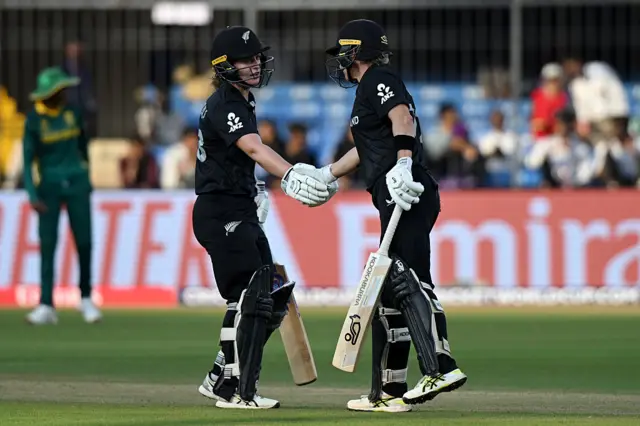 Sophie Devine of New Zealand (R) is congratulated by team mate Brooke Halliday