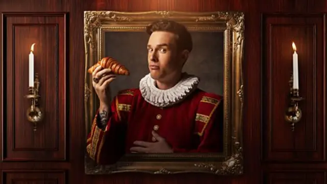 Ed Gamble holds a croissant in a portrait