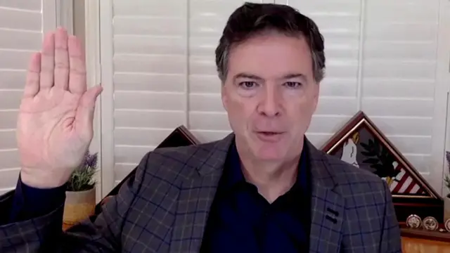 FILE PHOTO: James Comey, former director of the Federal Bureau of Investigation (FBI), is seen in a frame grab from a video feed as he is sworn in remotely from his home during a Senate Judiciary Committee hearing exploring the FBI's investigation of the 2016 Trump campaign and Russian election interference in Washington, U.S