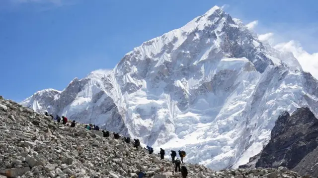 Mountaineers and trekkers head towards the Everest base camp from Lobuche in the Solukhumbu district, also known as the Everest region, Nepal April 12, 2025