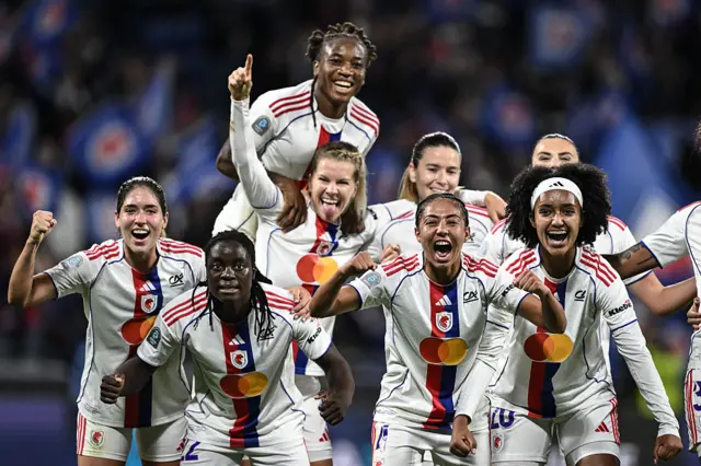 Lyonnes' Malawian forward Tabitha Chawinga (2L) celebrates with teammates after scoring her team's sixth goal during the French Premiere Ligue football match between OL Lyonnes (OL) and Paris-Saint-Germain (PSG