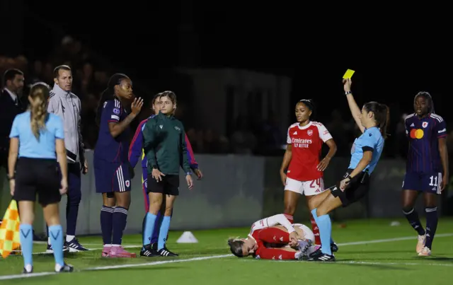 Olympique Lyonnais's Melchie Dumornay is shown a yellow card