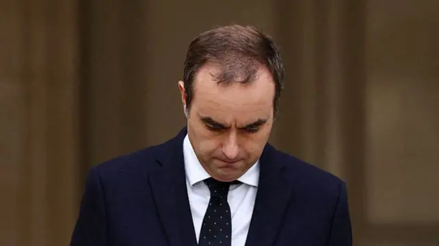 Lecornu looking down as he walks to deliver a statement outside at the  Hotel Matignon in Paris.