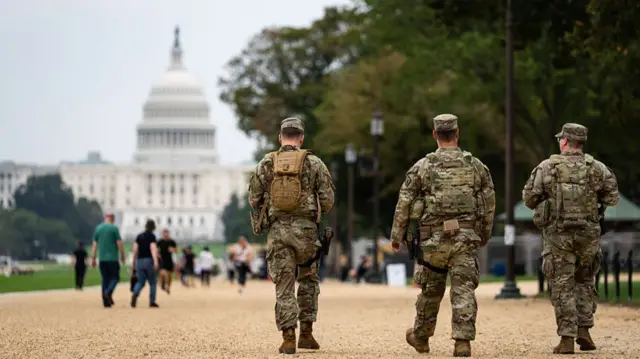 National Guard troops walk on the National Mall in Washington DC