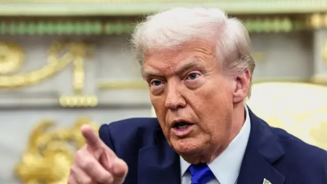 Trump points to a member of the media off camera