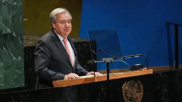 Antonio Guterres stands at a podium to deliver a speech