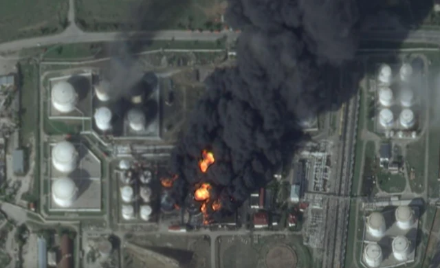 Satellite image of an oil depot in Feodosia, Russian Occupied Crimea taken on 8 October 2024. It shows a huge plume of smoke emitting from fuel tanks.
