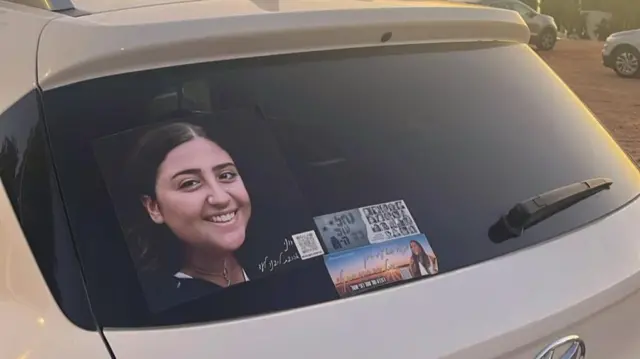 A picture of 19-year-old Roni Eshel, stuck onto the back mirror of a car