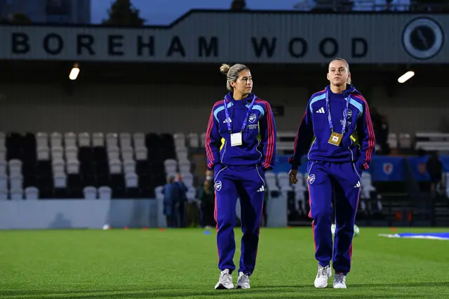 Kyra Cooney-Cross (L) and Alessia Russo of Arsenal inspects the pitch prior to the UEFA Women's Champions League 2025/26 league phase match between Arsenal FC and OL Lyonnesat Meadow Park on October 07, 2025 in Borehamwood, England.