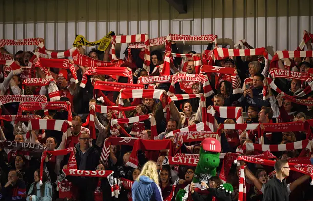 Arsenal fans shows their support by holding up their scarves in the stands prior to the UEFA Women's Champions League 2025/26 league phase match between Arsenal FC and OL Lyonnesat Meadow Park on October 07, 2025 in Borehamwood, England.