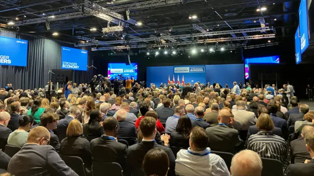 Picture shows packed Tory conference room