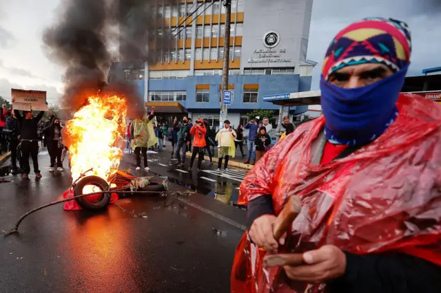 Protesters burning tires on the street in Ecuador