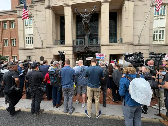Reporters wait outside court