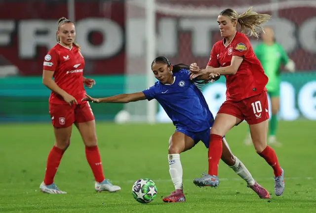 Alyssa Thompson of Chelsea is challenged by Jill Roord of FC Twente during the UEFA Women's Champions League 2025/26 league phase match between FC Twente and Chelsea FC Women at De Grolsch Veste