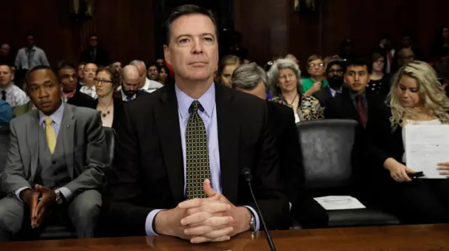 James Comey sitting at a table during a Senate committee hearing