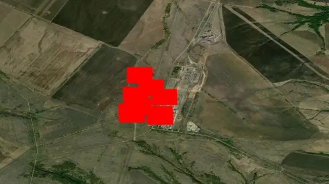 A satellite map with 6 large red rectangles around an industrial processing facility, which is used to indicate head spots by Nasa's Firms data