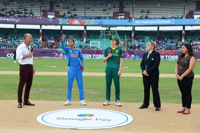 Harmanpreet Kaur of India tosses the coin alongside Laura Wolvaardt of South Africa