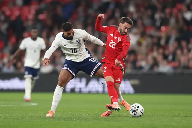 Ruben Loftus-Cheek of England and Joshua Sheehan of Wales battle for possession