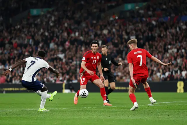 Bukayo Saka of England scores