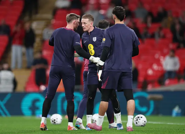 Dean Henderson, Jordan Pickford and James Trafford of England interact