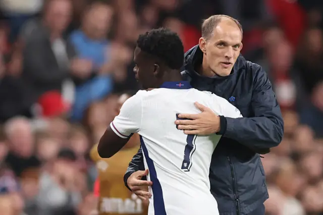 Bukayo Saka of England hugs Thomas Tuchel