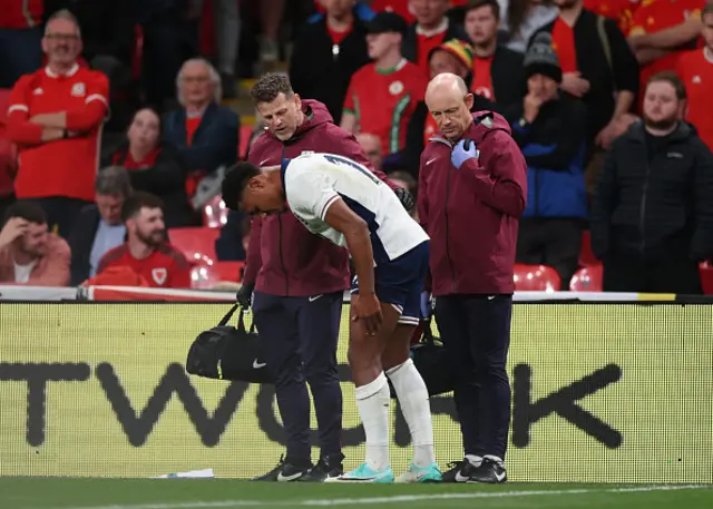 Ollie Watkins of England is checked on by England medical staff