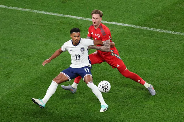 Ollie Watkins of England holds off a challenge from Joe Rodon